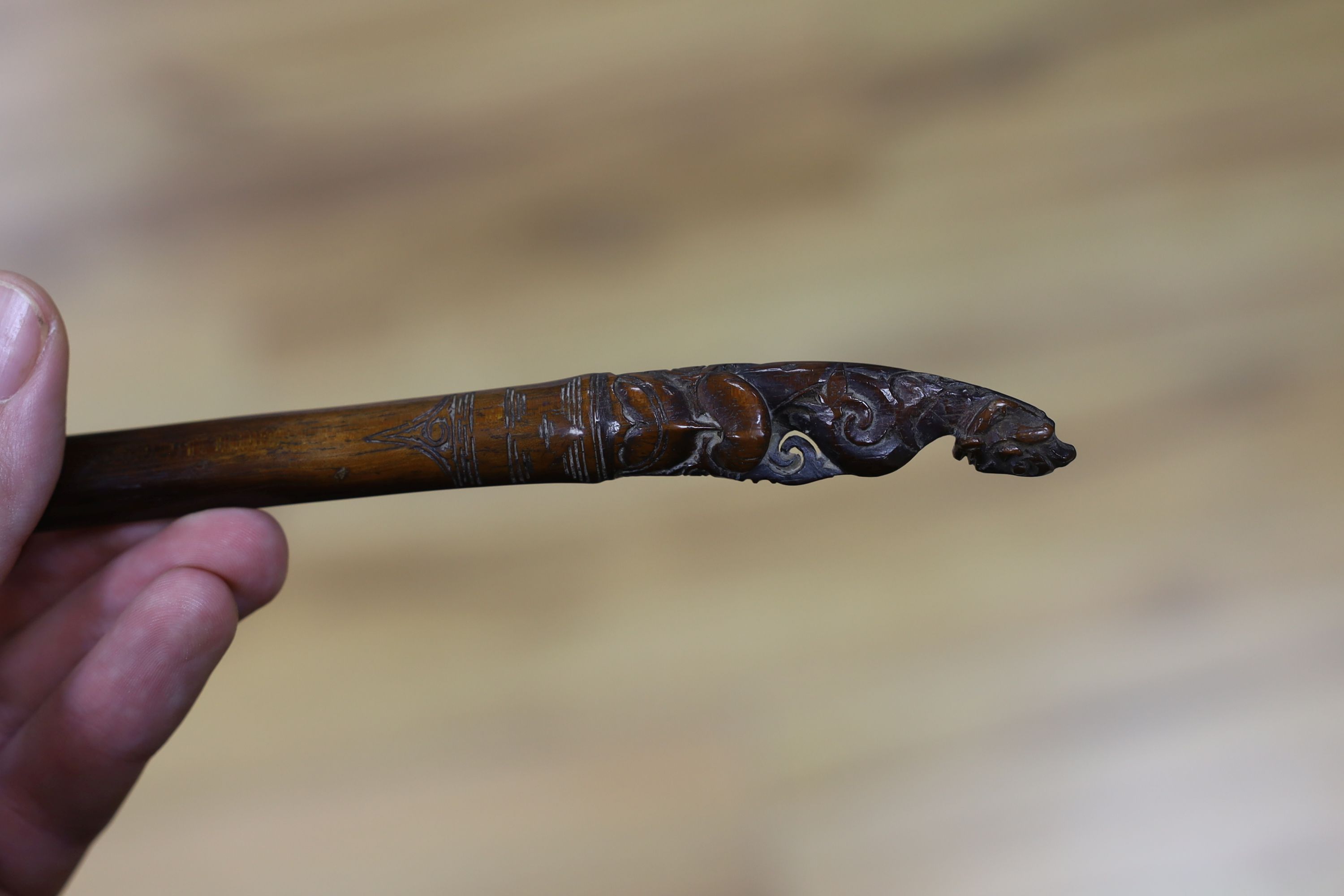 A Borneo 'headhunter's sword', a bone carving and feather swot (3), sword 77 cm long